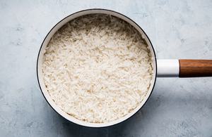 a sauce pan full of creamy coconut rice made with water, coconut milk, sugar and salt