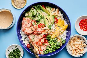 Coconut Rice Salmon Bowl with mango, cucumber, avocado, edamame, cilantro & coconut drizzled with coconut milk dressing