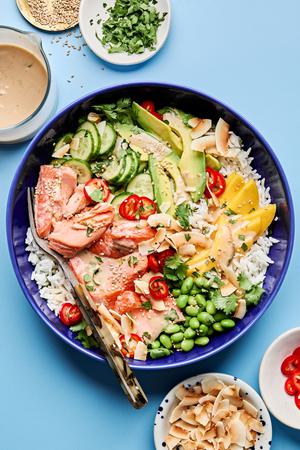Coconut Rice Salmon Bowl with mango, cucumber, avocado, edamame, cilantro & coconut drizzled with coconut milk dressing