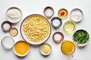 corn, green onions, flour, cornmeal, sugar, baking powder, salt, cayenne, and garlic powder, butter & oil in prep bowls