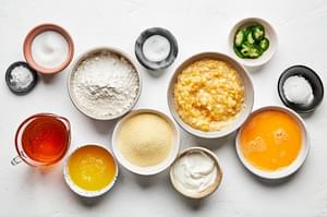 honey, jalapeño, flour, cornmeal, sugar, baking powder & soda, salt, creamed corn, eggs, butter and sour cream in prep bowls