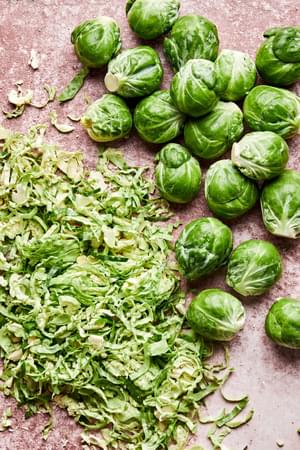 brussels sprouts being shaved to make creamed brussels sprouts