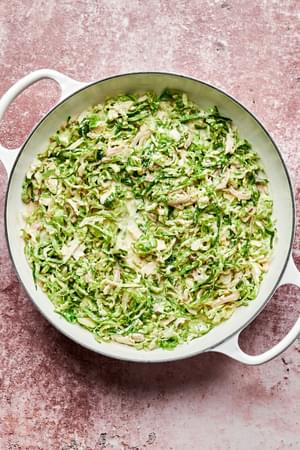 shaved brussels sprouts, shallot, garlic, heavy cream, stone ground mustard and spices cooking in a skillet