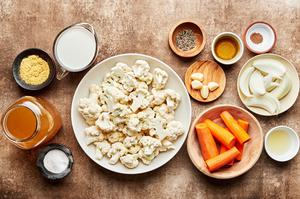cauliflower, carrots, onion, olive oil, nutritional yeast, garlic, stock, milk, lemon juices & spices in prep bowls