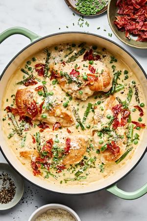 Creamy Chicken skillet with Asparagus & Peas topped with prosciutto, chives, Parmesan & pepper