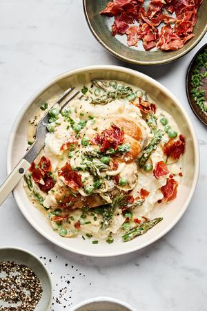 Creamy Chicken with Asparagus & Peas served on top of mashed potatoes and topped with prosciutto, chives, Parmesan & pepper