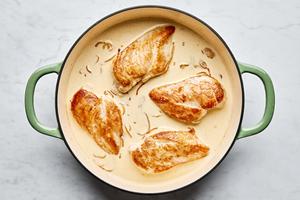 chicken nestled in cream sauce made with shallot, garlic, chicken stock, bouillon, Parmesan and salt