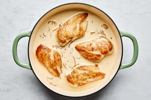 chicken nestled in cream sauce made with shallot, garlic, chicken stock, bouillon, Parmesan and salt