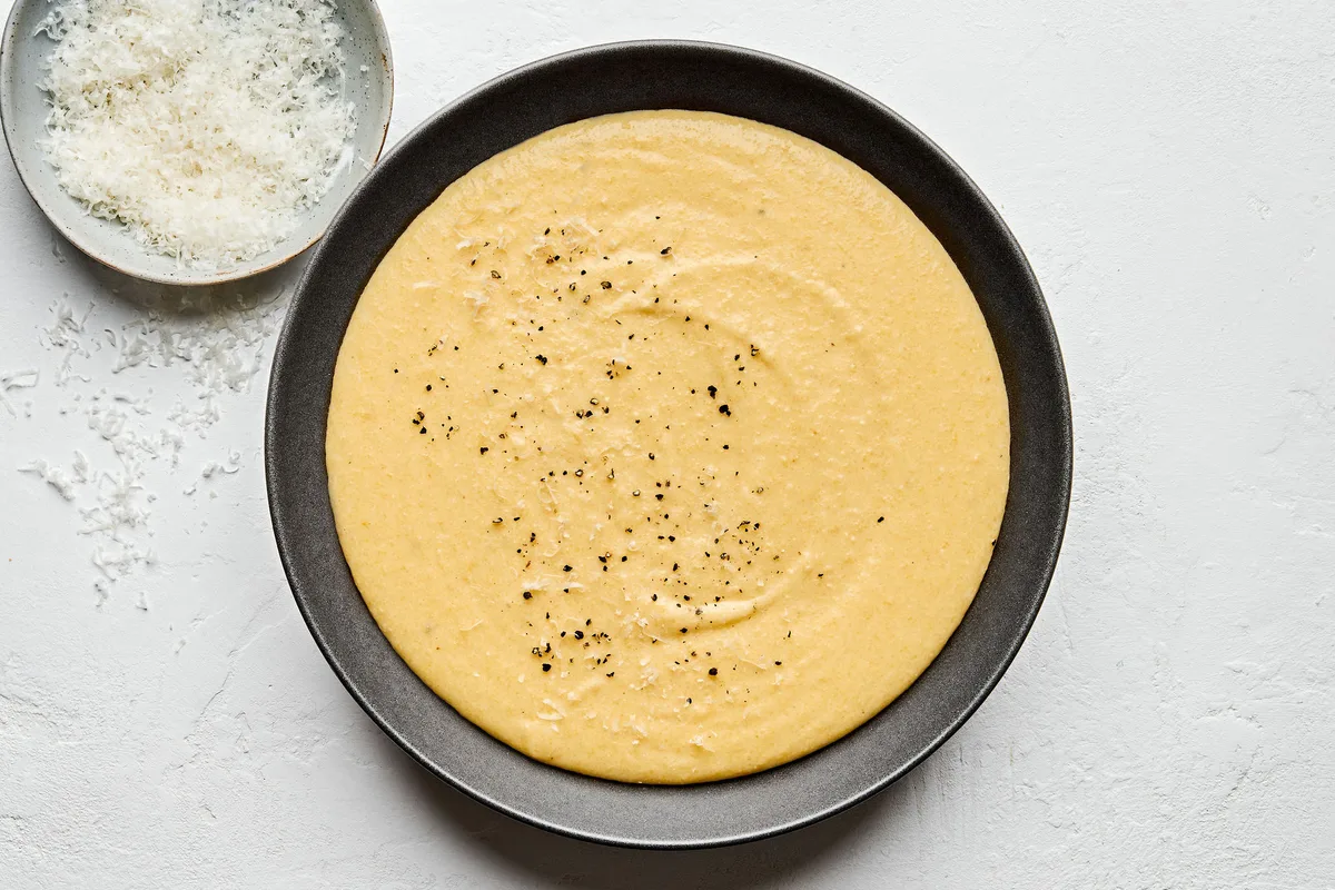 a bowl of homemade polenta made with milk, chicken stock, butter, salt, pepper and Parmesan