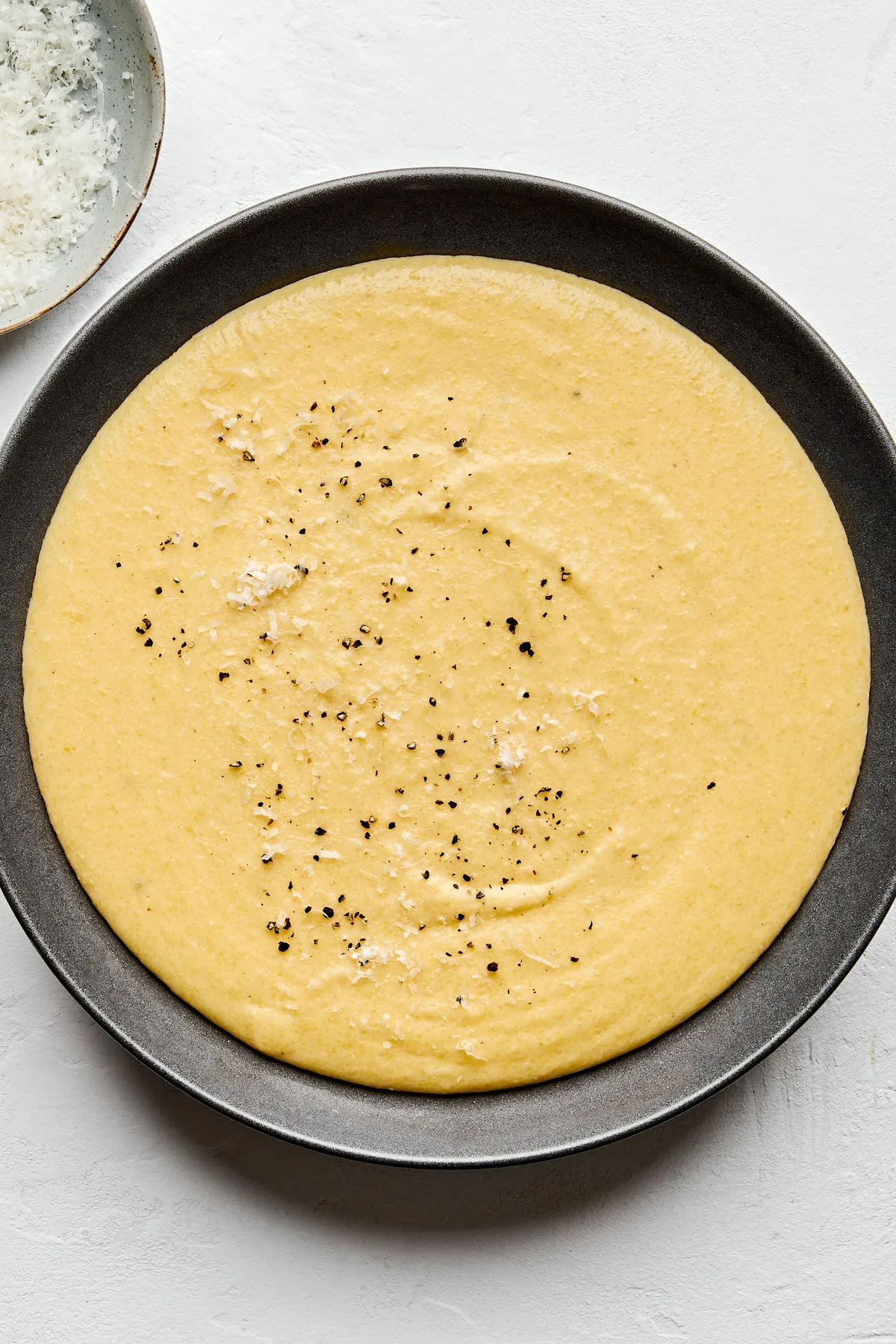 a bowl of homemade polenta made with milk, chicken stock, butter, salt, pepper and Parmesan
