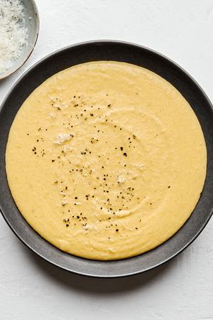 a bowl of homemade polenta made with milk, chicken stock, butter, salt, pepper and Parmesan