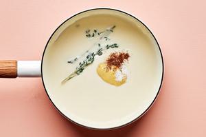 homemade Béchamel sauce in a pot made with butter, flour, milk, thyme, dijon, salt and nutmeg