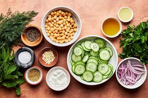 cucumbers, chickpeas, red onion, parsley, mint, dill, yogurt, lemon juice, olive oil, garlic, salt, pepper & za'atar in bowls