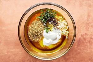 greek yogurt, yogurt, juice, olive oil, fresh mint, garlic, salt, pepper & za'atar in a glass bowl
