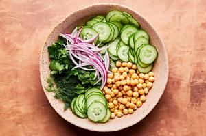 cucumbers, chick peas, red onion, mint and parsley in a large bowl