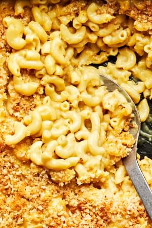 baked dairy free mac and cheese topped with panko bread crumbs in a 9x13 baking dish