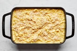 dairy free mac and cheese topped with panko bread crumbs in a 9x13 baking dish