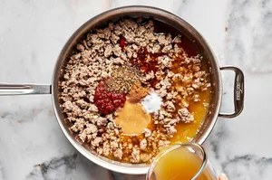 pork, spices, soy sauce, sherry, chicken stock, peanut butter, Sichuan peppercorns, sugar & chili paste in a skillet