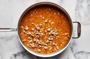 pork, spices, soy sauce, sherry, chicken stock, peanut butter, Sichuan peppercorns, sugar & chili paste in a skillet