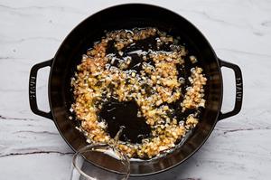 shallots and garlic cooking in a skillet