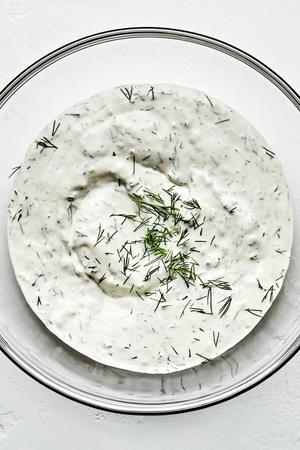 dill dip made with olive oil, mayo, sour cream, garlic, dill, garlic powder, onion powder, lemon juice, salt & pepper