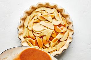 Dutch apple pie filling being poured into a pie crust