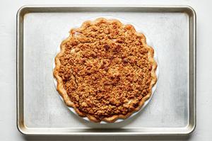 a dutch apple pie fresh from the oven cooling on a baking sheet