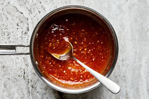 a pan of orange sauce made with orange zest, orange juice, soy sauce, chili-garlic paste, sugar, garlic & rice wine vinegar.