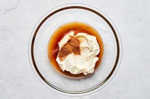 mascarpone, maple syrup, cinnamon, and vanilla mixed together in a bowl for a creamy tiramisu filling.