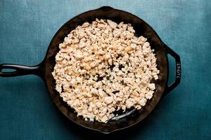 ground turkey, onion, ginger and garlic being cooked in a skillet