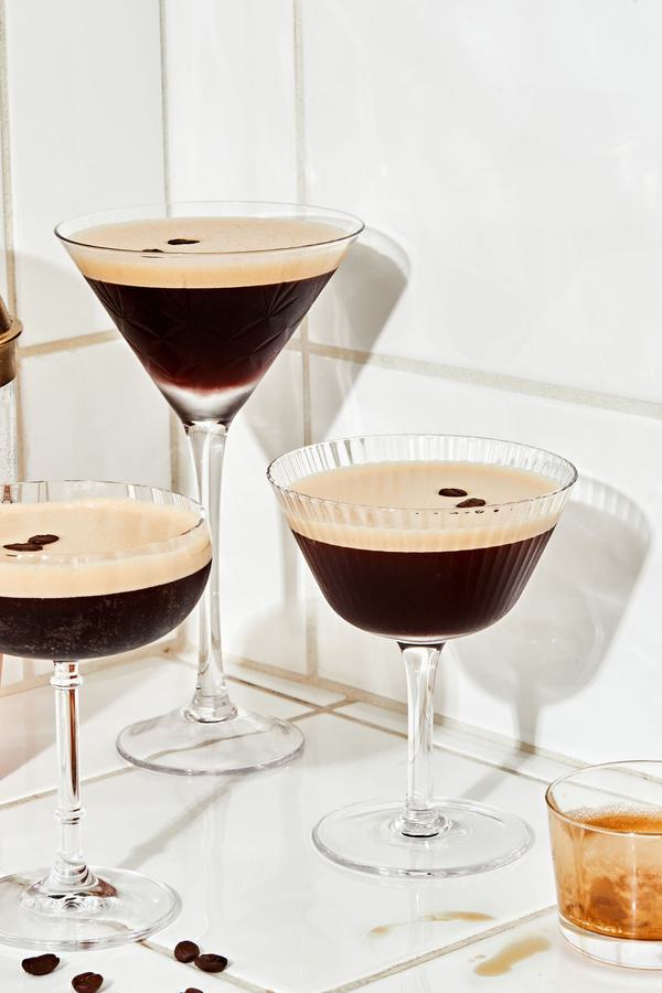3 espresso martinis garnished with coffee beans on the counter