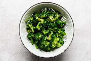 blanched broccoli in a colander