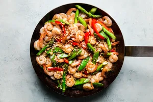 Garlic Shrimp Stir Fry in a pan with asparagus, snow peas, red bell peppers