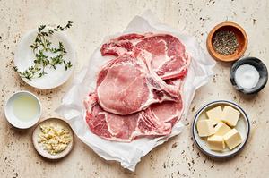pork chops, Vegetable oil, butter, thyme, garlic, salt and pepper in prep bowls to make garlic butter pork chops