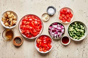 Roma tomatoes, bell pepper, cucumber, onion, garlic, olive oil, sherry, salt, and pepper in prep bowls