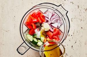 Roma tomatoes, bell pepper, cucumber, onion, garlic, olive oil, sherry, salt, and pepper in a blender