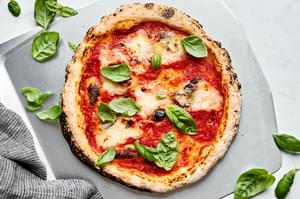 cheese pizza made with homemade gluten free pizza dough on a pizza peel