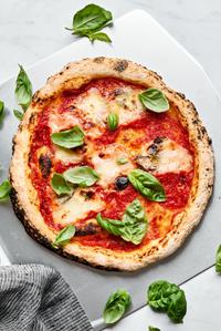 cheese pizza made with homemade gluten free pizza dough on a pizza peel