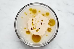 gluten free flour, salt, yeast mixture and olive oil in a mixing bowl