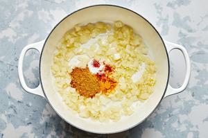 onion, olive oil, ginger, garlic, curry powder, turmeric, sea salt, and cayenne cooking in a pot