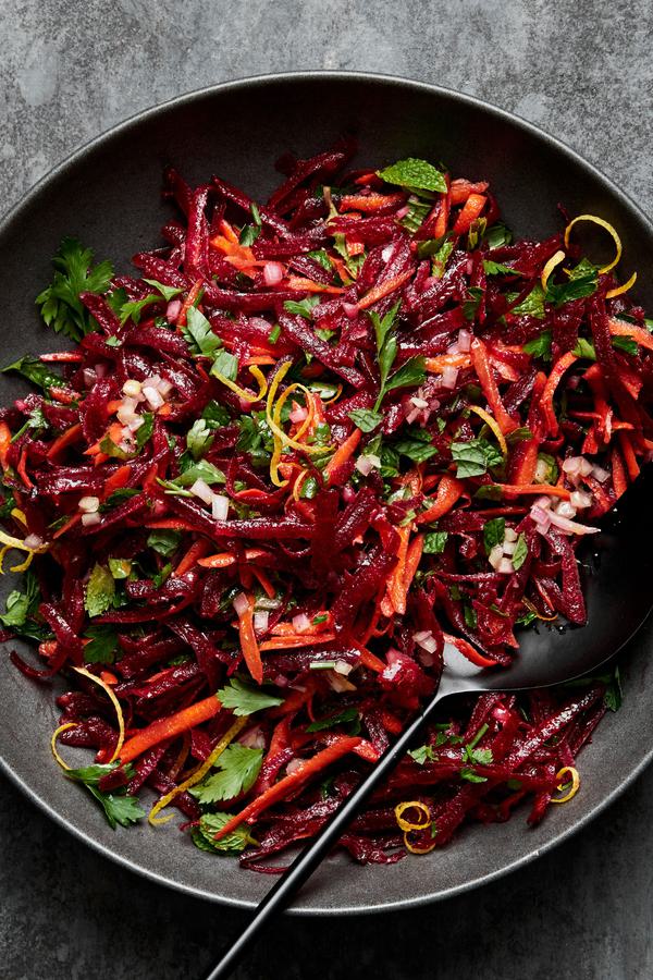 grated beet salad made with grated carrots, parsley, mint and homemade honey mustard dressing in a serving bowl