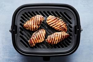 Greek marinated chicken being grilled