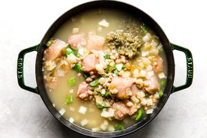 Green Chicken Chili Soup in a stockpot getting ready to be simmered
