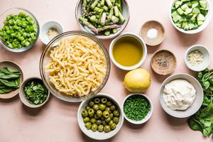 ingredients for green goddess pasta salad olives, chives, basil, green onions, garlic, asparagus, cucumbers, dijon, lemon