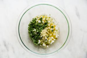 onions, lime juice, orange juice, oregano, garlic and cilantro in a small glass bowl