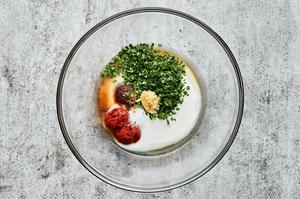 coconut milk, red curry paste, fish sauce, cilantro, lime juice, salt, brown sugar, and garlic combined in a small glass bowl