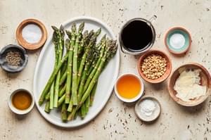 asparagus, salt, pepper, olive oil, balsamic, honey, pine nuts and parmesan in prep bowls