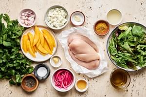 ingredients for Grilled Curry Chicken Salad with Herb Vinaigrette in prep bowls on the counter