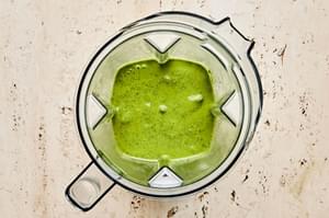 herb vinaigrette in a blender made with shallot, olive oil, vinegar, mustard, honey, garlic, salt, pepper, cilantro and mint
