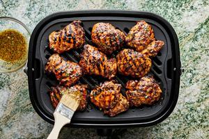 chicken being grilled and brushed with honey mustard marinade